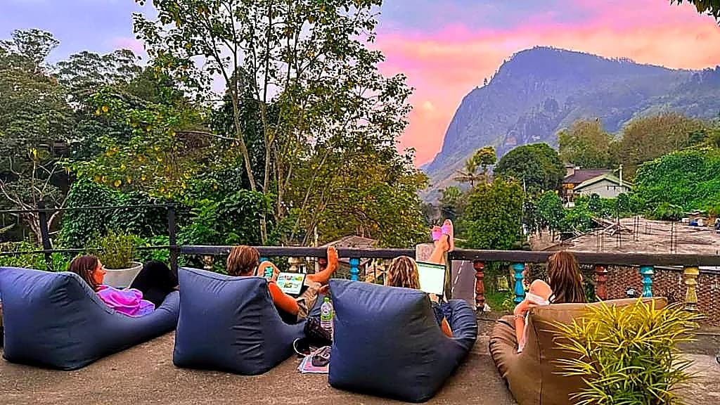 Guests on beanbags watching the sunset from the terrace